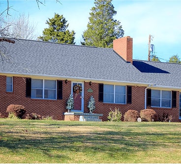 house with tile roof and expert gutter installation, roofing winston salem, roof repair greensboro, roofing company high point, roof repair mount airy, local gutter installation