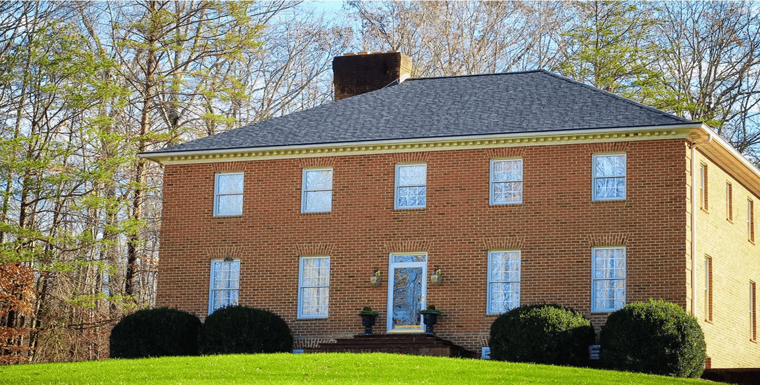 square brick house showcasing roof installation from a Winston Salem NC roofing company