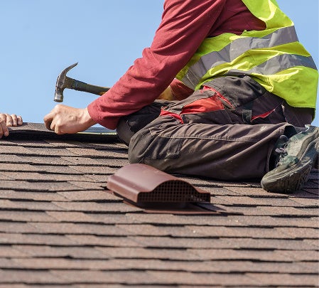 man nailing roof, roofing winston salem, roof repair greensboro, roofing company high point, roof repair mount airy 