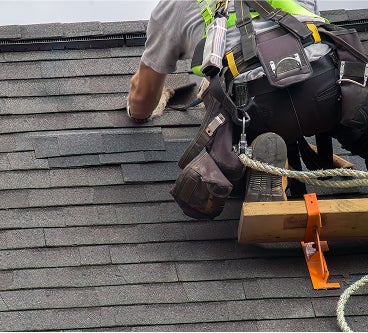 worker building roof, roofing winston salem, roof repair greensboro, roofing company high point, roof repair mount airy, local gutter installation